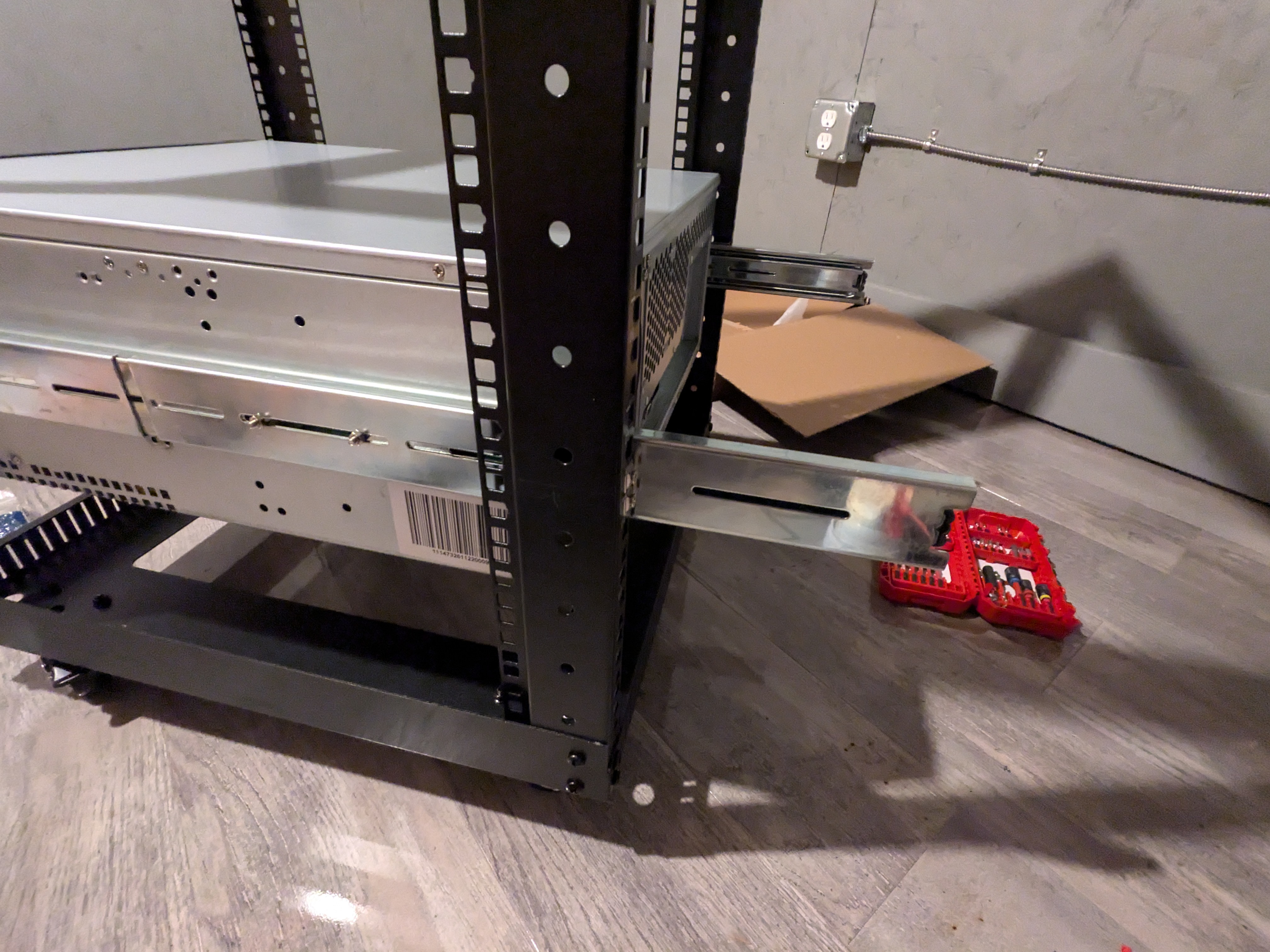 Image of a server rack with rails that are a few inches too long